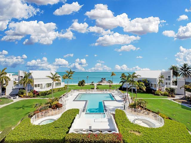 Oceanfront residences around a swimming pool and landscaped grounds